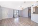 Bright living room with gray walls, wood-look flooring, and large windows at 3107 Mapleshade St, Deltona, FL 32738
