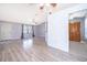 Open-concept living area with wood-look floors and neutral paint at 3107 Mapleshade St, Deltona, FL 32738