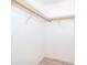 Spacious walk-in closet featuring wooden rods and white painted walls at 3107 Mapleshade St, Deltona, FL 32738