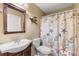 This charming bathroom boasts a decorative shower curtain, vanity, and a unique wall decor at 313 Dirksen Dr # A5, Debary, FL 32713