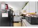 The kitchen has a black refrigerator next to the sink, below white cabinets at 313 Dirksen Dr # A5, Debary, FL 32713