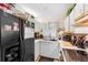 A black refrigerator is next to the sink and a white tile counter top at 313 Dirksen Dr # A5, Debary, FL 32713