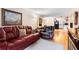 Comfortable living room with a red leather couch and view to the kitchen at 313 Dirksen Dr # A5, Debary, FL 32713
