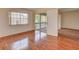 A bright bedroom featuring hardwood floors and sliding glass doors leading to a balcony at 313 Dirksen Dr # B15, Debary, FL 32713