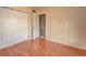 Bedroom featuring hardwood floors and a double-door closet for storage at 313 Dirksen Dr # B15, Debary, FL 32713