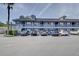 Exterior shot of a multi-Gathering building, featuring parking spaces and a palm tree on a sunny day at 313 Dirksen Dr # B15, Debary, FL 32713