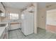 Bright, compact kitchen featuring essential appliances, neutral countertops, and tile flooring at 313 Dirksen Dr # B15, Debary, FL 32713