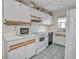 Well-lit kitchen with white cabinetry, a microwave and tile flooring at 313 Dirksen Dr # B15, Debary, FL 32713