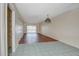 Spacious living room with tile and wood flooring, a sliding glass door, and neutral paint at 313 Dirksen Dr # B15, Debary, FL 32713