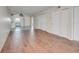 Bright living area with hardwood flooring that flows to an adjacent white kitchen at 313 Dirksen Dr # B15, Debary, FL 32713