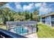An elevated, screened-in pool boasts clear blue water, a Jacuzzi, and green landscaping at 313 Dirksen Dr # B15, Debary, FL 32713