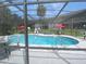 A screened-in pool area features a sparkling pool, lounge chairs, and landscaping at 313 Dirksen Dr # B15, Debary, FL 32713