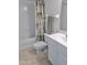 Bright bathroom with tub, shower, and sink, complemented by neutral tones and a palm-themed shower curtain at 3311 S Atlantic Ave # 604, Daytona Beach Shores, FL 32118