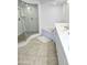 Bright bathroom featuring a glass shower, separate tub, and double sink vanity for convenience at 3311 S Atlantic Ave # 604, Daytona Beach Shores, FL 32118
