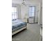 Cozy bedroom features two windows for natural light, ceiling fan, and wicker dresser for style at 3311 S Atlantic Ave # 604, Daytona Beach Shores, FL 32118