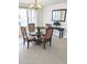 Bright dining room featuring a glass table, chandelier, and large window for an elegant dining experience at 3311 S Atlantic Ave # 604, Daytona Beach Shores, FL 32118