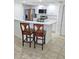 Kitchen with modern stainless steel appliances, white cabinets, bar seating, and updated countertops at 3311 S Atlantic Ave # 604, Daytona Beach Shores, FL 32118