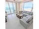 The living room has ocean views, bright floors, comfortable seating, and balcony access at 3311 S Atlantic Ave # 604, Daytona Beach Shores, FL 32118