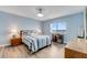 Bedroom featuring wood-look floors, a desk, a ceiling fan, and a large window with a view at 3606 S Peninsula Dr # 507, Port Orange, FL 32127