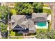 Stunning aerial view showcasing the home's architecture, lush landscaping, and inviting backyard pool in a peaceful neighborhood at 3698 Lower Park Rd, Orlando, FL 32814
