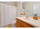 Cozy bathroom features a single sink vanity, framed mirror, and shower with white curtain at 3698 Lower Park Rd, Orlando, FL 32814