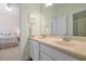 Dual sink vanity with a framed mirror; doorway to the bedroom and shower visible at 3698 Lower Park Rd, Orlando, FL 32814
