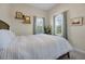 Bright bedroom with a neutral color palette, stylish decor, and two large windows at 3698 Lower Park Rd, Orlando, FL 32814