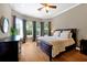 Cozy bedroom featuring hardwood floors, large windows, and neutral decor, creating a serene retreat at 3698 Lower Park Rd, Orlando, FL 32814