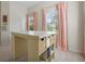 Sunny room with pink curtains and storage desk, providing a bright and functional space at 3698 Lower Park Rd, Orlando, FL 32814