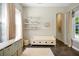 Bright bonus room with a window bench, decorative shelves, and a cozy rug at 3698 Lower Park Rd, Orlando, FL 32814