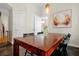 Dining room featuring a wood table under modern lighting and colorful art at 3698 Lower Park Rd, Orlando, FL 32814