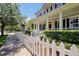 Inviting two-story home with a welcoming front porch, white columns, and neatly trimmed hedges at 3698 Lower Park Rd, Orlando, FL 32814