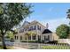 Lovely two-story home showing side angle of the house, well-maintained yard and charming white picket fence at 3698 Lower Park Rd, Orlando, FL 32814