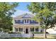 Charming two-story home featuring a welcoming front porch, white picket fence, and well-manicured landscaping at 3698 Lower Park Rd, Orlando, FL 32814