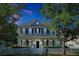 Charming two-story home featuring a welcoming front porch, white picket fence, and well-manicured landscaping at 3698 Lower Park Rd, Orlando, FL 32814