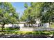 Charming single-story home featuring a classic white picket fence and lush landscaping at 3698 Lower Park Rd, Orlando, FL 32814