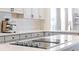 Close-up of kitchen island with cooktop and barstool seating at 3698 Lower Park Rd, Orlando, FL 32814