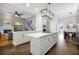 Modern kitchen with white cabinets, quartz countertops, open layout, and modern appliances at 3698 Lower Park Rd, Orlando, FL 32814