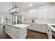 Modern kitchen with white cabinets, quartz countertops, and stainless steel appliances at 3698 Lower Park Rd, Orlando, FL 32814