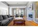 Bright and airy living room with hardwood floors, a fireplace, and comfortable seating at 3698 Lower Park Rd, Orlando, FL 32814