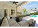 This expansive patio features comfortable seating and is perfect for entertaining, overlooking the lush backyard and sparkling pool at 3698 Lower Park Rd, Orlando, FL 32814