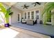 Relaxing covered patio with comfortable seating, ceiling fans, and a stylish outdoor setting for serene outdoor living at 3698 Lower Park Rd, Orlando, FL 32814