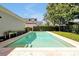 Enjoy a refreshing swim in this pristine backyard pool, surrounded by travertine and lush landscaping for ultimate privacy at 3698 Lower Park Rd, Orlando, FL 32814