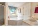 Bathroom featuring a large soaking tub with a shower and a window view at 3733 Cardinal Blvd # 1, Daytona Beach, FL 32118