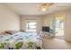 Bright bedroom with ceiling fan and sliding door to the balcony at 3733 Cardinal Blvd # 1, Daytona Beach, FL 32118