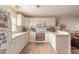 Bright kitchen featuring white cabinetry, a breakfast bar, and tiled floors at 3733 Cardinal Blvd # 1, Daytona Beach, FL 32118