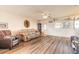 Cozy living room features wood flooring and a ceiling fan at 3733 Cardinal Blvd # 1, Daytona Beach, FL 32118