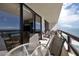 Wide balcony with table and chairs, offering ocean views and seamless indoor/outdoor living at 3855 S Atlantic Ave # 1405, Daytona Beach, FL 32118