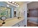 This elegant bathroom features a vanity with mirrors, decorative accents, and a tiled shower-tub combo at 3855 S Atlantic Ave # 1405, Daytona Beach, FL 32118