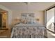 Bright bedroom features stylish, coastal-themed decor and a comfortable bed overlooking the outside balcony at 3855 S Atlantic Ave # 1405, Daytona Beach, FL 32118